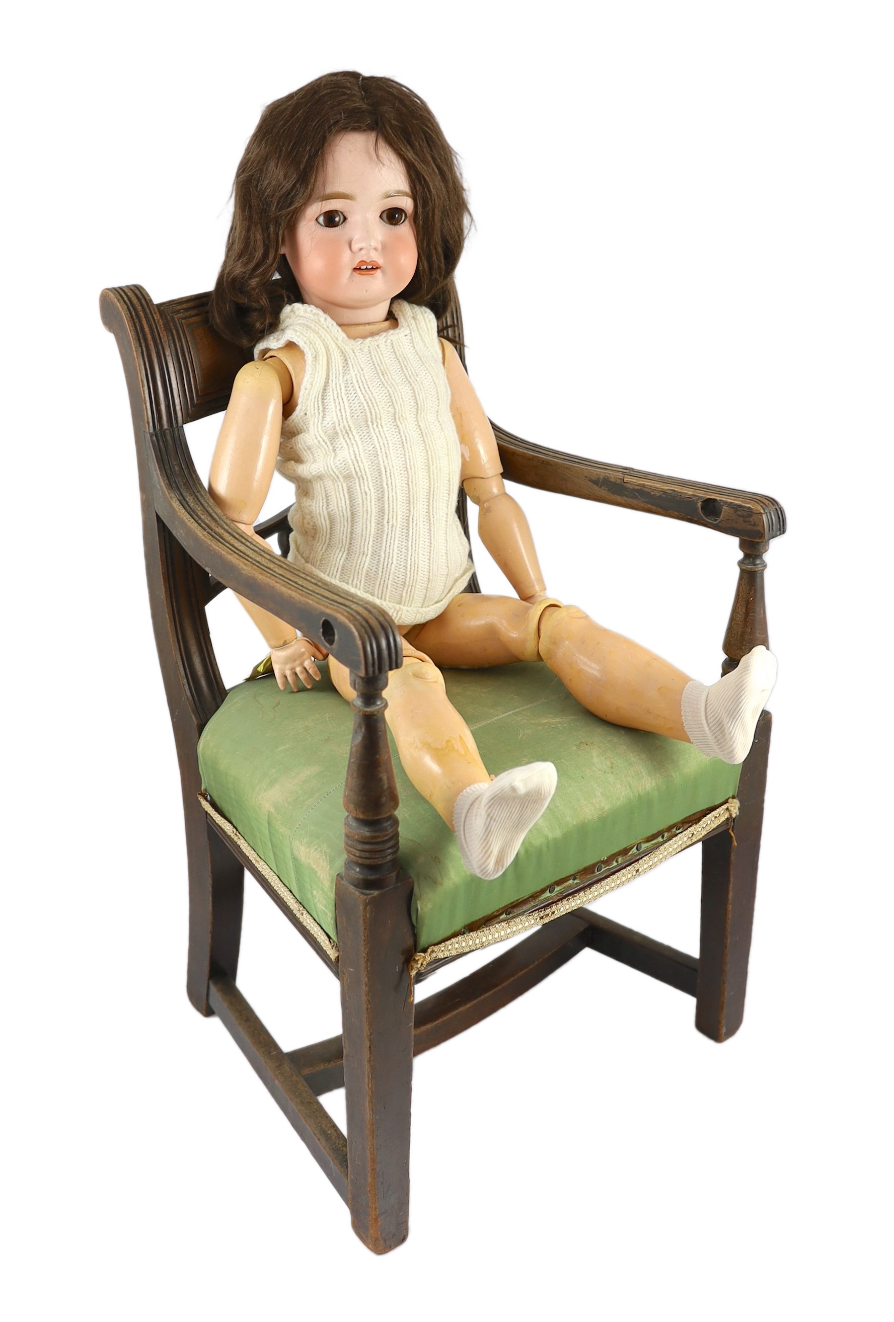 A bisque doll, German, circa 1900, 28in. Please note the chair is for display purposes only.